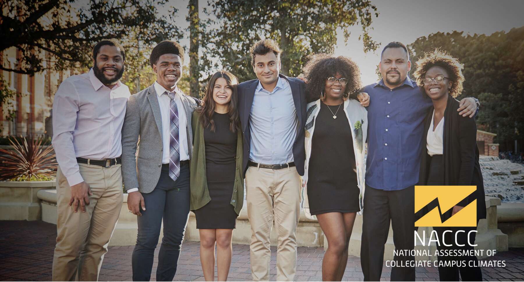 Seven students standing shoulder to shoulder and smiling